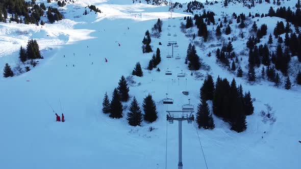 Aerial Winter Scene of Alpine Snowy Mountain Peaks and Dark Spruce Forest in Snow