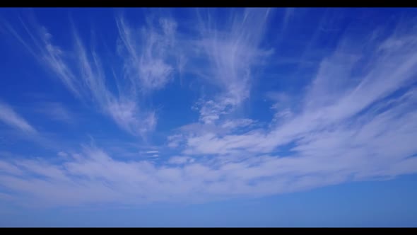 Aerial panorama of exotic tourist beach vacation by aqua blue lagoon and white sandy background of j