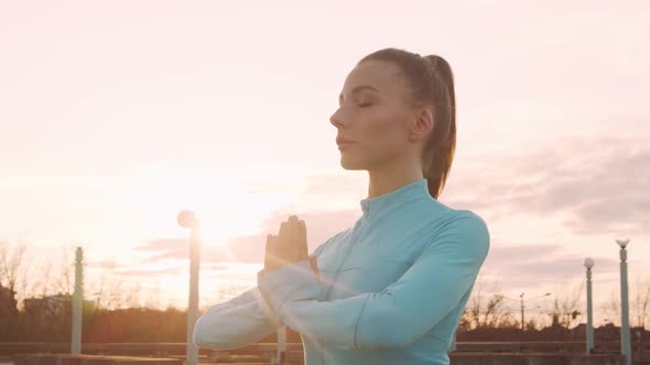 Young, beautiful and sporty woman having evening training outdoor.