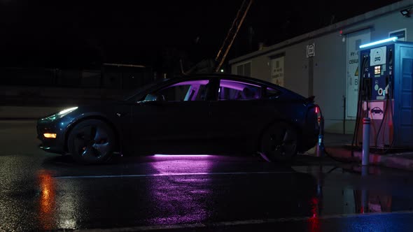 Electric Car Charging at EV Station at Night