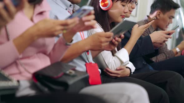 Young People Using Mobile Phone in Public Underground Train