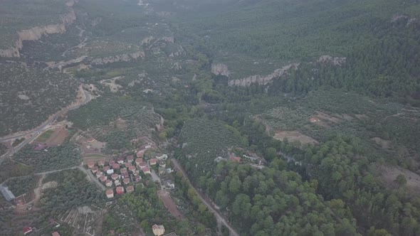 Aerial clip of village nestled among trees and mountains in Geyikbayiri area in Antalya Turkey