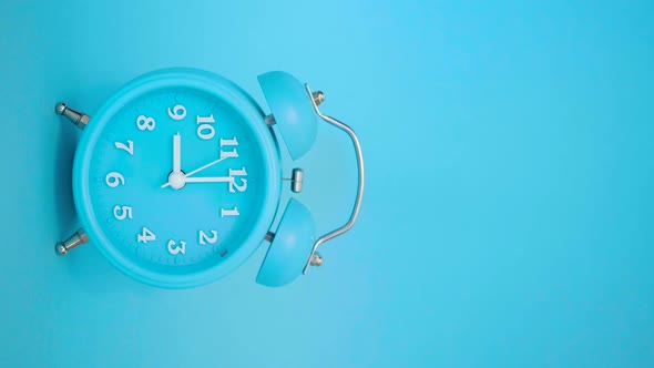 Blue Alarm Clock on a Blue Background Rings at 9 AM  Vertical Video