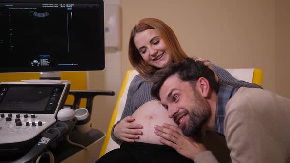 Future Father Listening To Baby in Wife's Belly