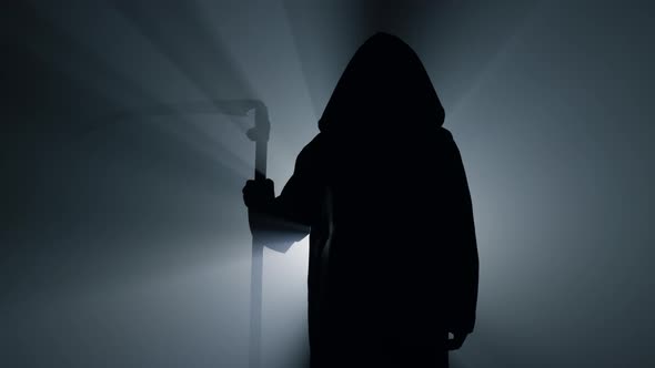 Silhouette Grim Reaper Waiting with Scythe Indoors