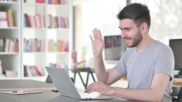 Video Chat on Laptop By Young Man in Office