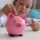 Little Girl Saves Money with a Piggy Bank at Home - VideoHive Item for Sale