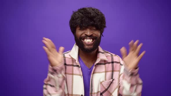 Casual African American Man Applauding Against Purple Background