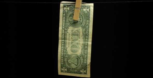 One Dollar Hanging from a Rope on Black