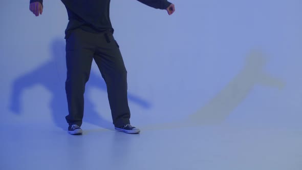 Man Dancing Hip Hop on Colour Changing Neon Background in Studio