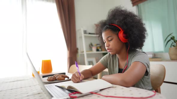 4K Little African girl online study on laptop computer with teacher