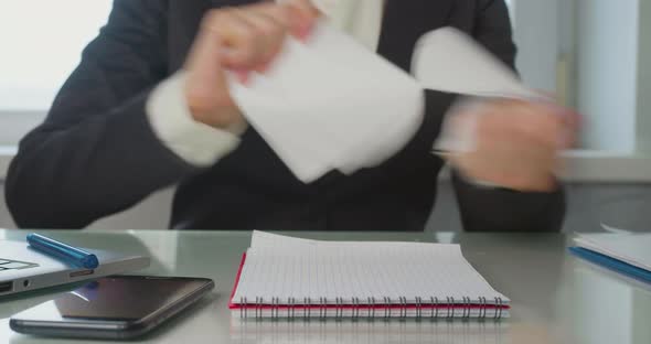 Office  a Woman Reads the Contract Finds a Critical Error and Tears the Paper to Shreds