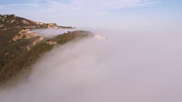 Drone Flying Fast Through White Clouds at Sunset Aerial Mountains Landscape