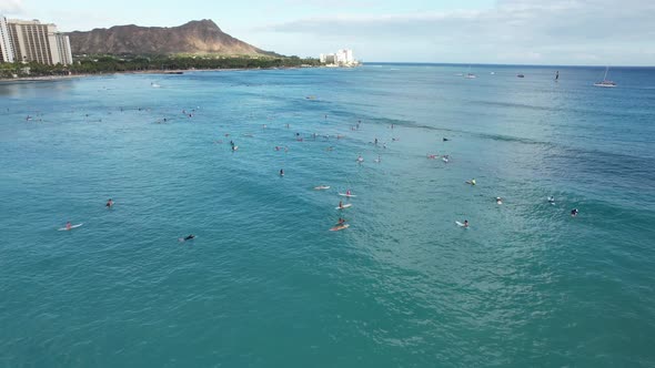 Surfers wait for waves at a popular tropical beach surf location.