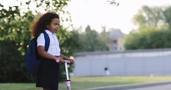 Child Rides a Scooter