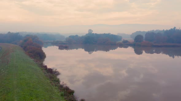Landscape with lake view at misty autumn morning in Central Europe. Panoramic plane. Shift. Aerial v