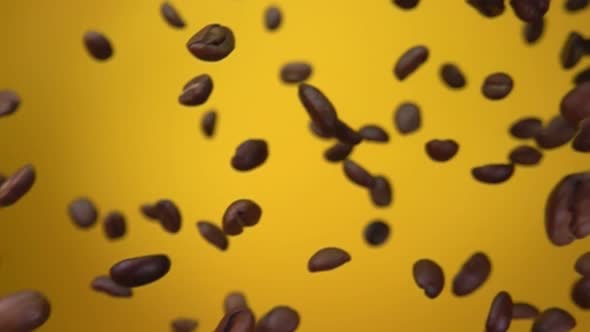 Roasted Arabica Coffee Beans are Flying Diagonally on the Yellow Background
