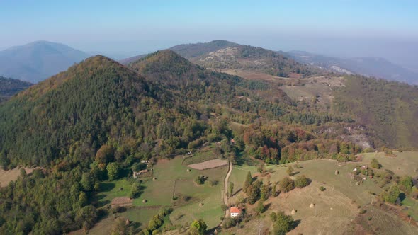 Autumn mountain with peaks, meadows and colorful forests