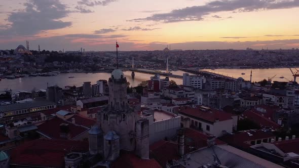 Aerial is flying sideways showing Galata Tower in Istanbul after sunset, Turkey