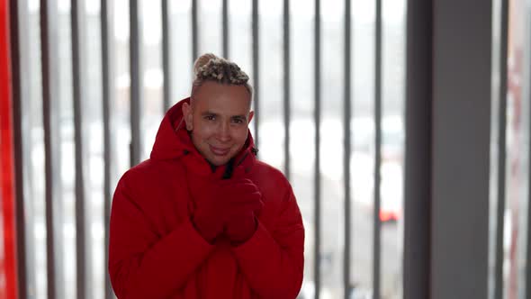 Closeup Portrait of a Happy Homosexual Man with Dreadlocks in His Hair Outside in a Warm Red Jacket