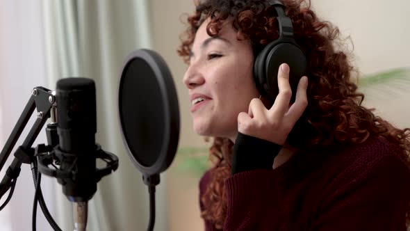 Latin singer recording song for new album inside music production studio