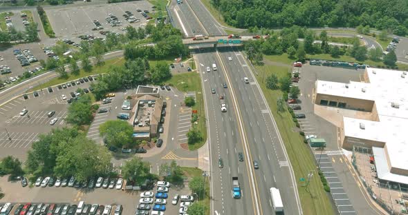 Asphalt Road Going Through Small Typical Settlement and Green Trees on the Horizon Live Aerial View