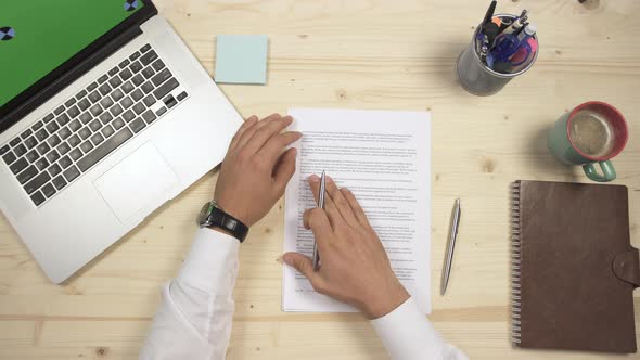 Putting on glasses and signing documents