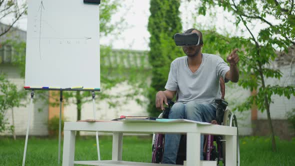 Talented Creative African American Disabled Man in Wheelchair Using VR Headset Designing Project on