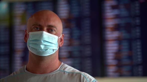 Middle-aged Man with Facial Mask in Airport or Station, Measures To Prevent Coronavirus Infection