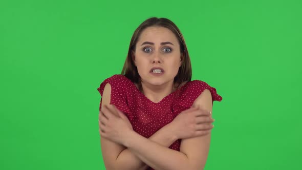 Portrait of Tender Girl in Red Dress Girl Froze and Trying To Keep Warm. Green Screen