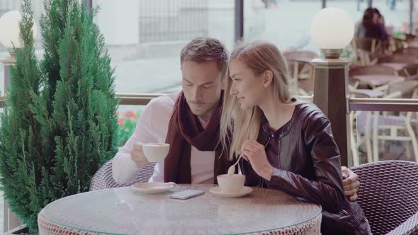 Romantic Couple Drinking Coffee On Date At Street Cafe