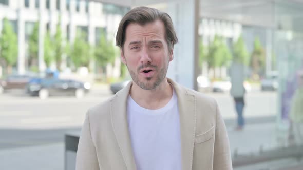 Outdoor Portrait of Shocked Young Man Wondering in Awe