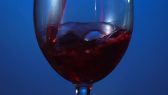 Red Wine Pouring Into the Glass Close Up