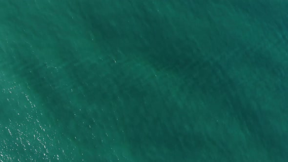 Aerial Top Down View From High Altitude of Green Sea Water Texture. The Camera Flies Over the Water
