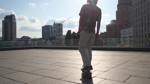 Active Male Skater Picking Up Board During Riding