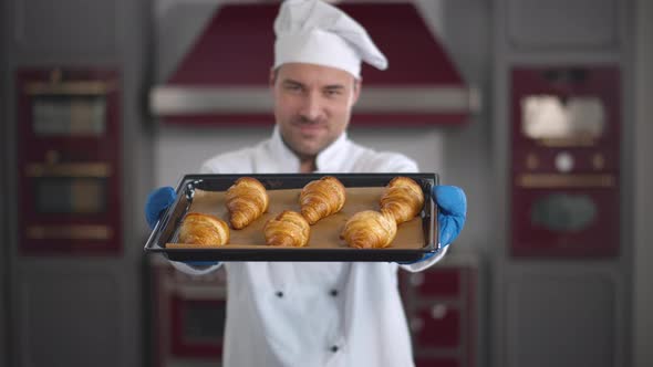 Portrait of Male Chef with Tray of Croissants at Pastry Shop