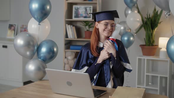 College Graduate Joyful Female Student in Mantle and an Academic Cap is Happy Ending Distance