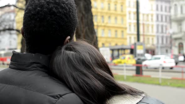 Couple Look on the Urban Street in the City - Black Man and Asian Woman - Cars and Passing Tram