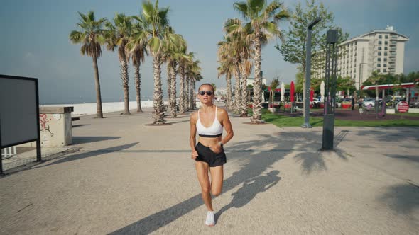 Young Caucasian Woman Running at Seaside