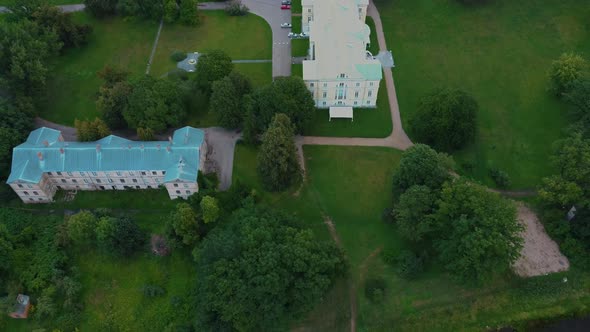 Mezotne Palace and Park With Fountain in Latvia. Lielupe River With Ponton Bridge Aerial 4K