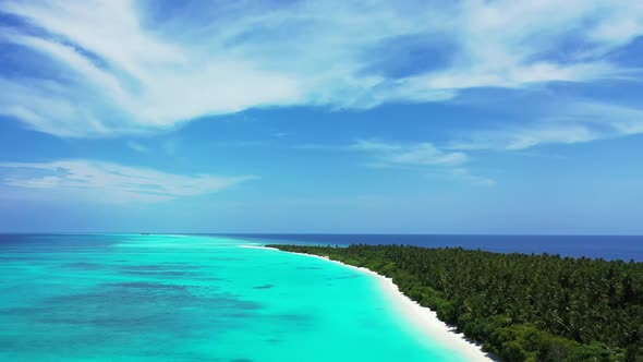 Aerial flying over seascape of paradise island beach trip by blue ocean with white sand background o