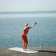 A Woman Practices Yoga Alone on the Seashore - VideoHive Item for Sale