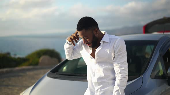 Busy Bearded African American LGBT Man Talking on the Phone in Slow Motion Gesturing Standing at Car