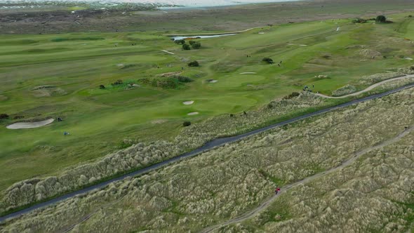 Aerial view over  marram grass anchored dunes and golf course