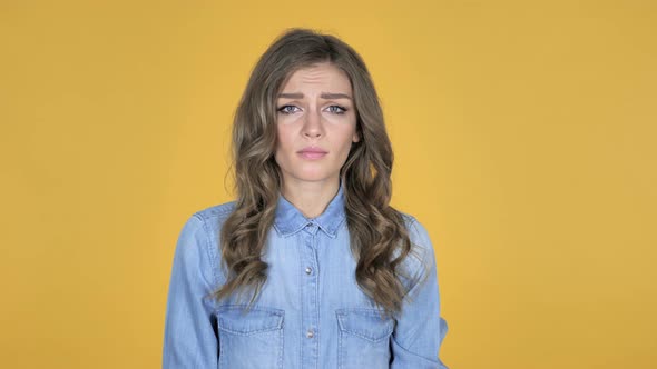 Surprised Young Girl in Shock Isolated on Yellow Background Wondering