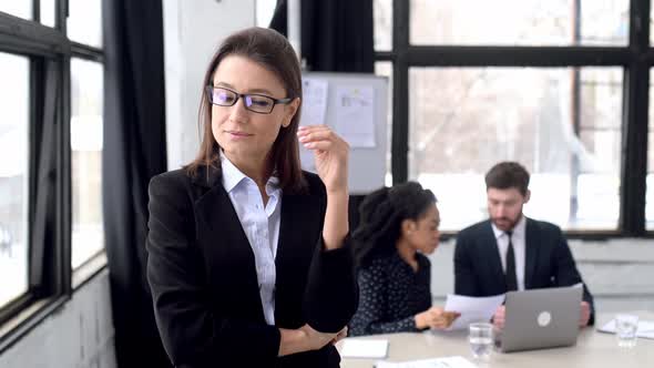 Portrait of Pretty Elegant Business Woman in Formal Clothes with Glasses