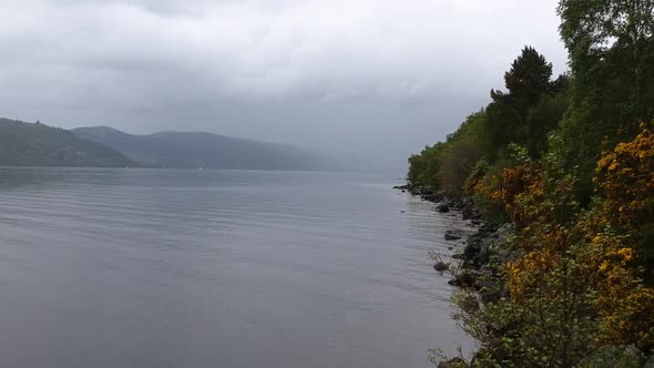 Panning droneshot of foggy Loch Ness Lake