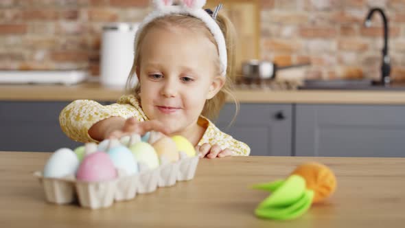 Video of playful girl steals handmade carrot from the table. Shot with RED helium camera in 8K.