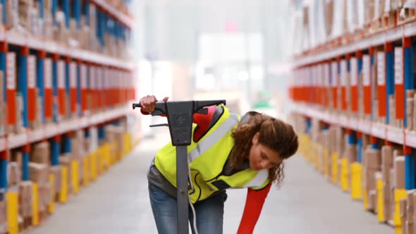 Female warehouse worker cleaning warehouse floor