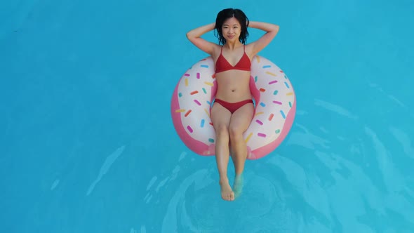 Japanese Student Is Resting on Summer Vacation in the Home Pool. Asian Nationality Ethnic Teenager